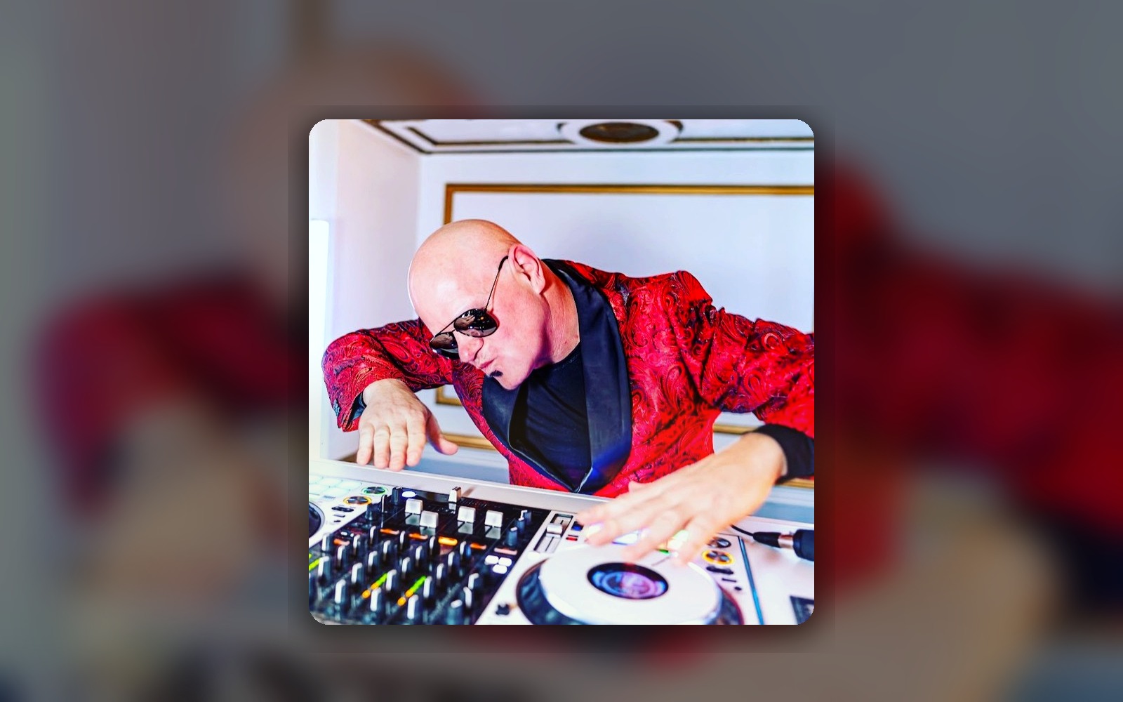 Mashup Charlie in a red jacket behind the turntables