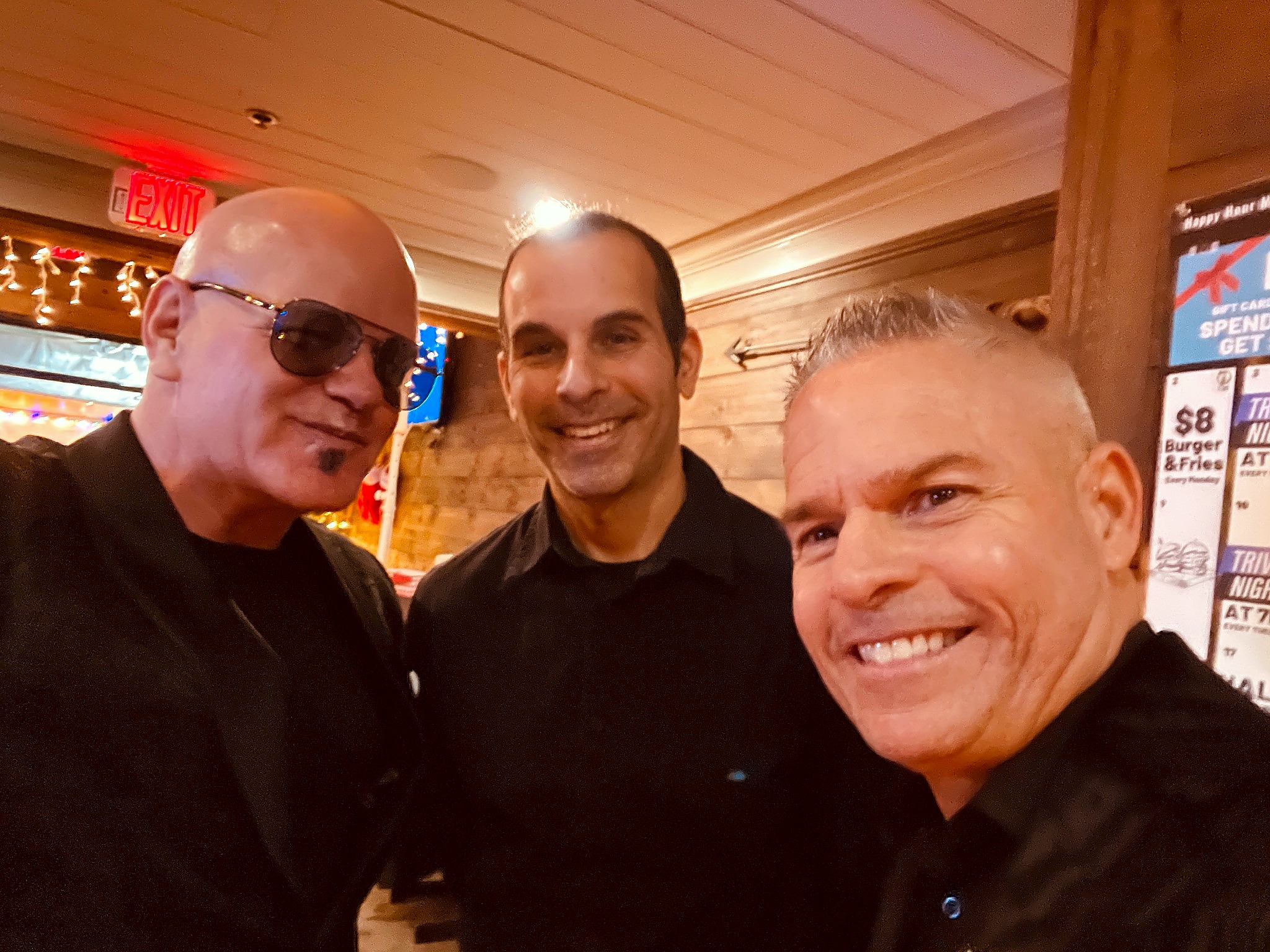 Mashup Charlie with teammates in a warm wood venue